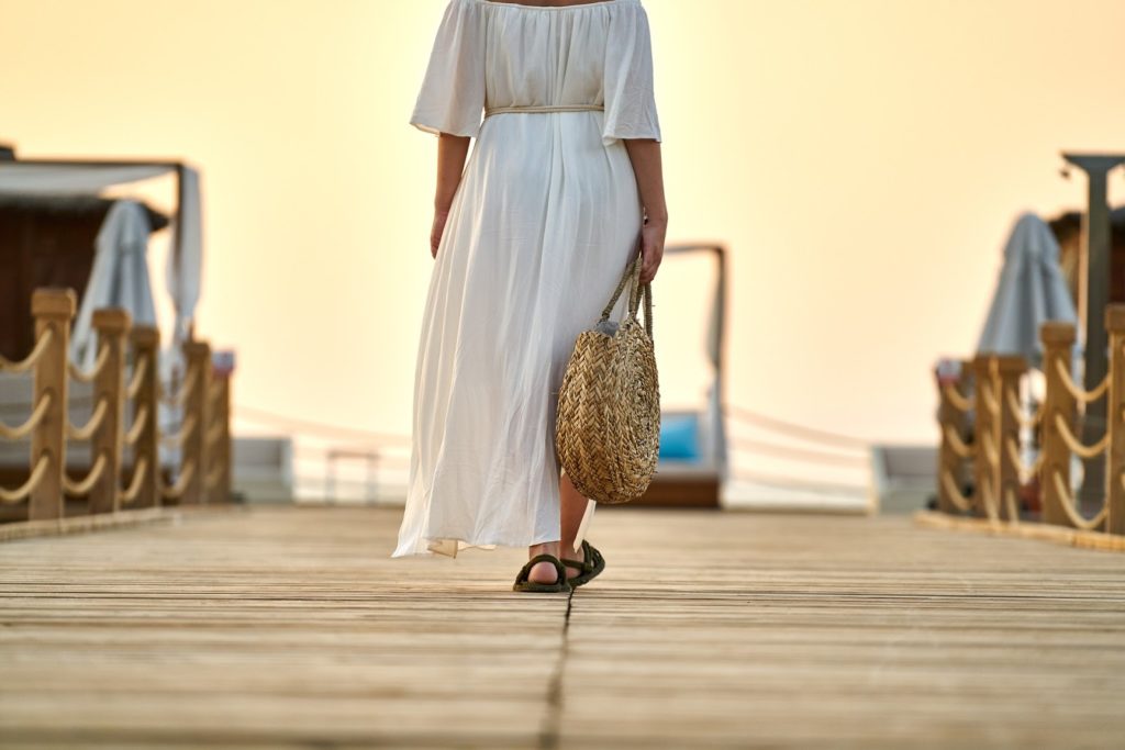 a woman wearing loose fitting and breathable clothing to help her stay cool