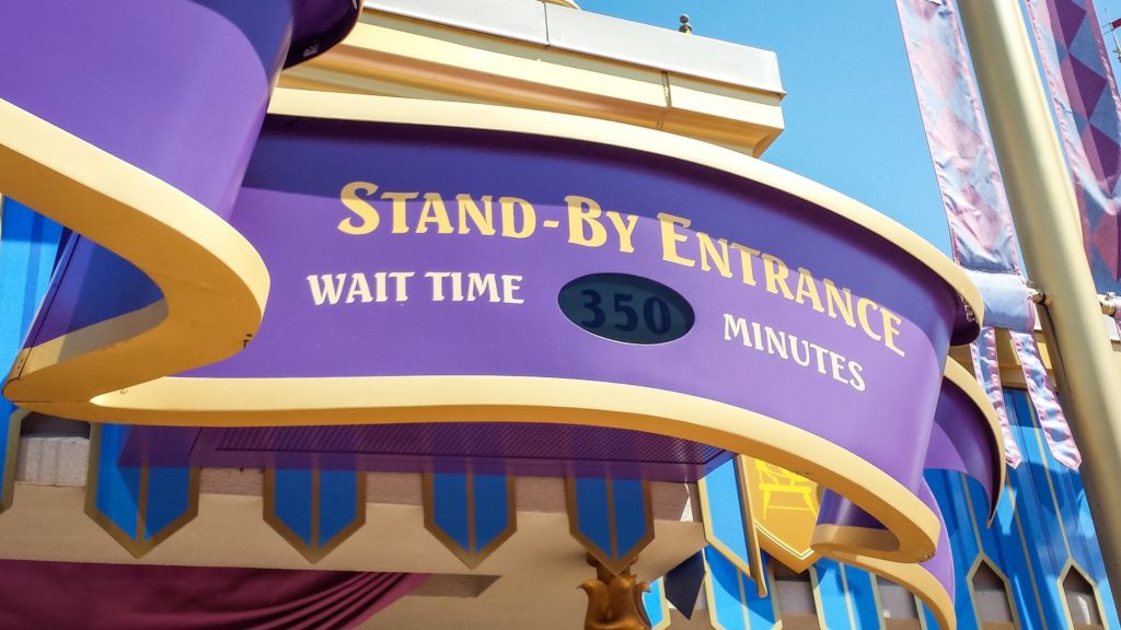 a sign showing the wait time for a popular disney attraction