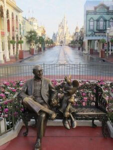 Roy Disney sitting with Minnie Mouse