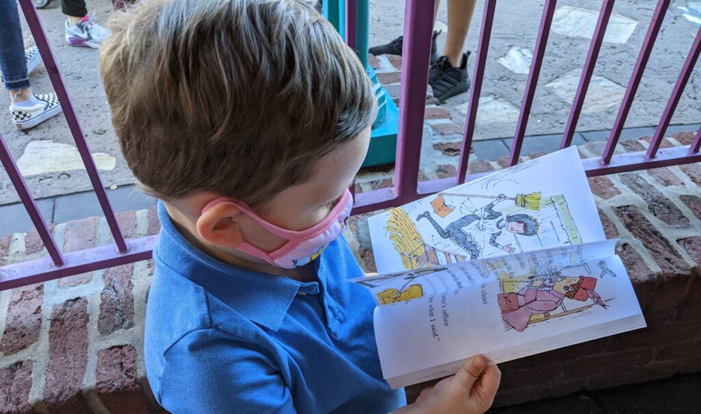 Lincoln Reading His Favorite Book In Line at Disney World