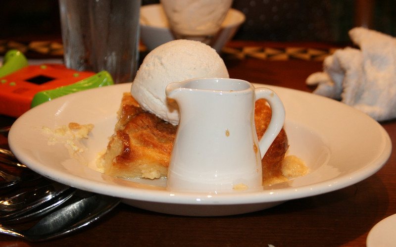 Bread pudding served a la mode with bananas and caramel sauce