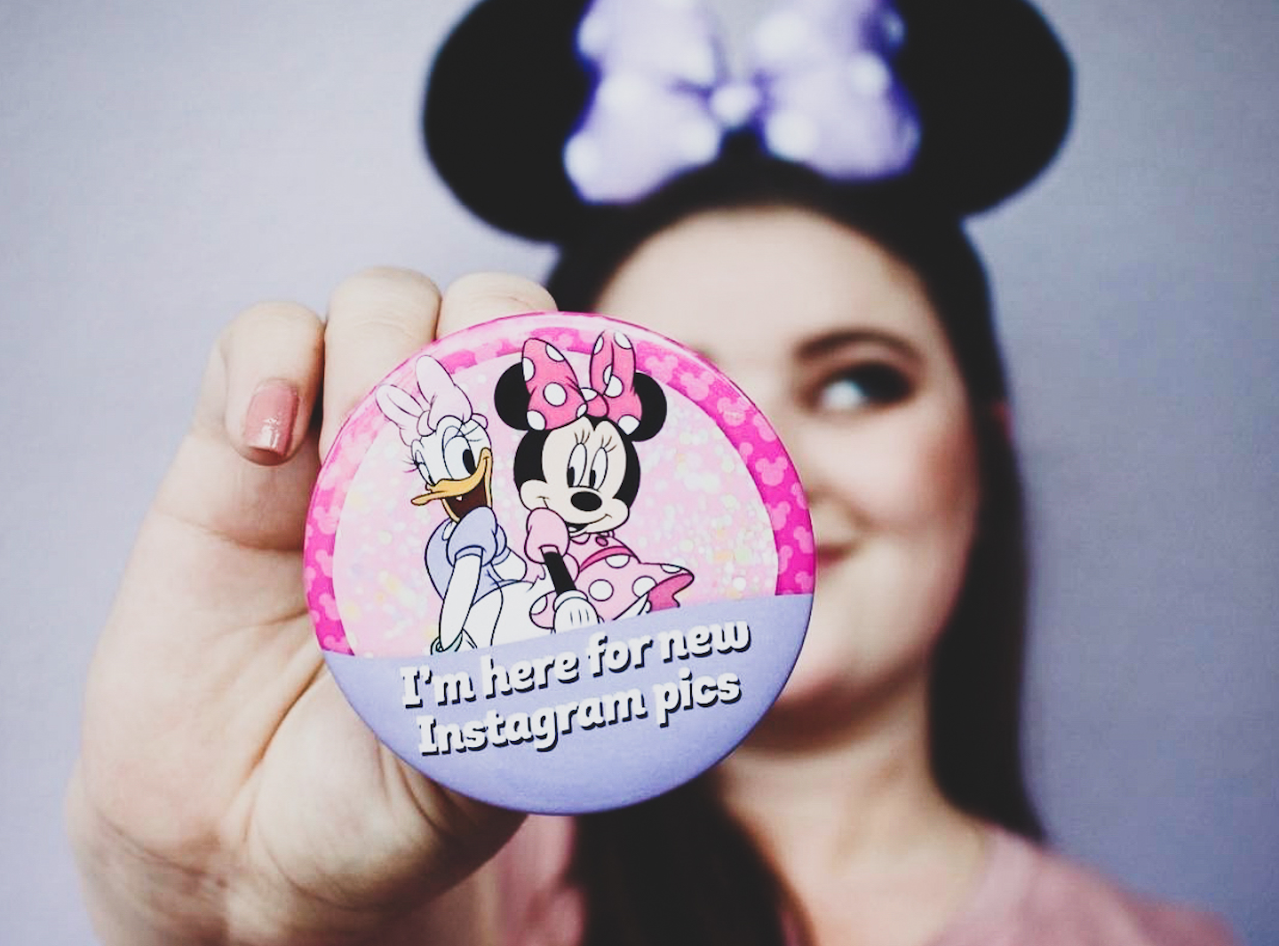 Girl holding Instagram Minnie and Daisy Disney Button
