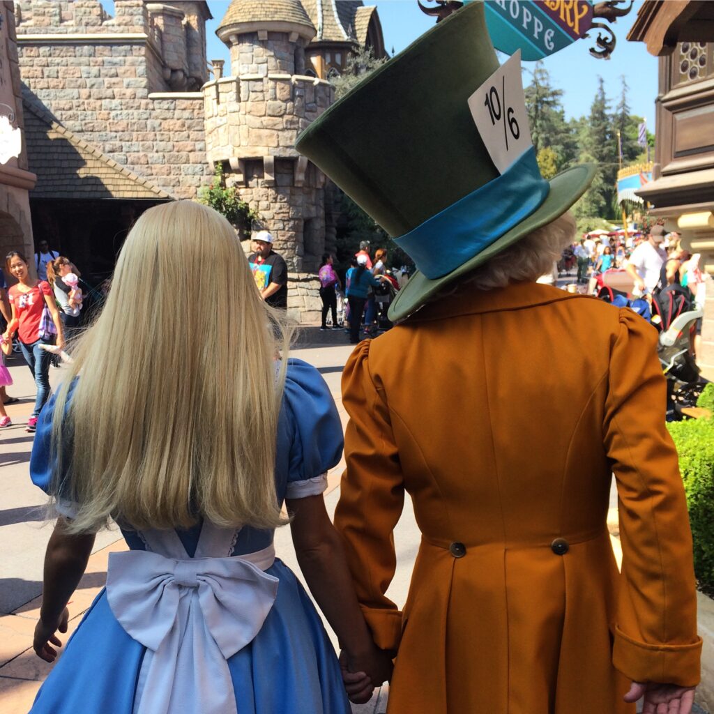 Alice and the Mad Hatter walking through Fantasyland - Disneyland