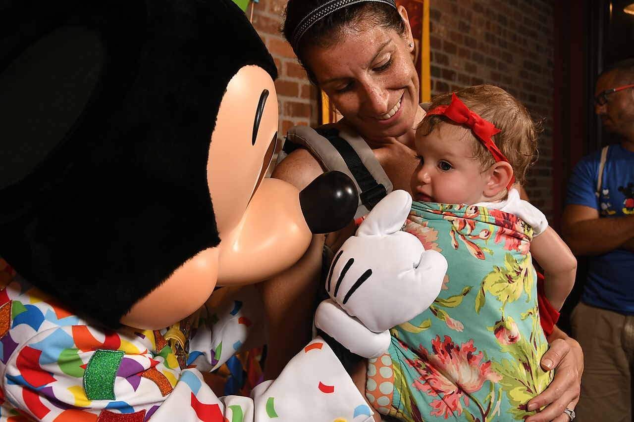 Mom and daughter meeting Mickey Mouse