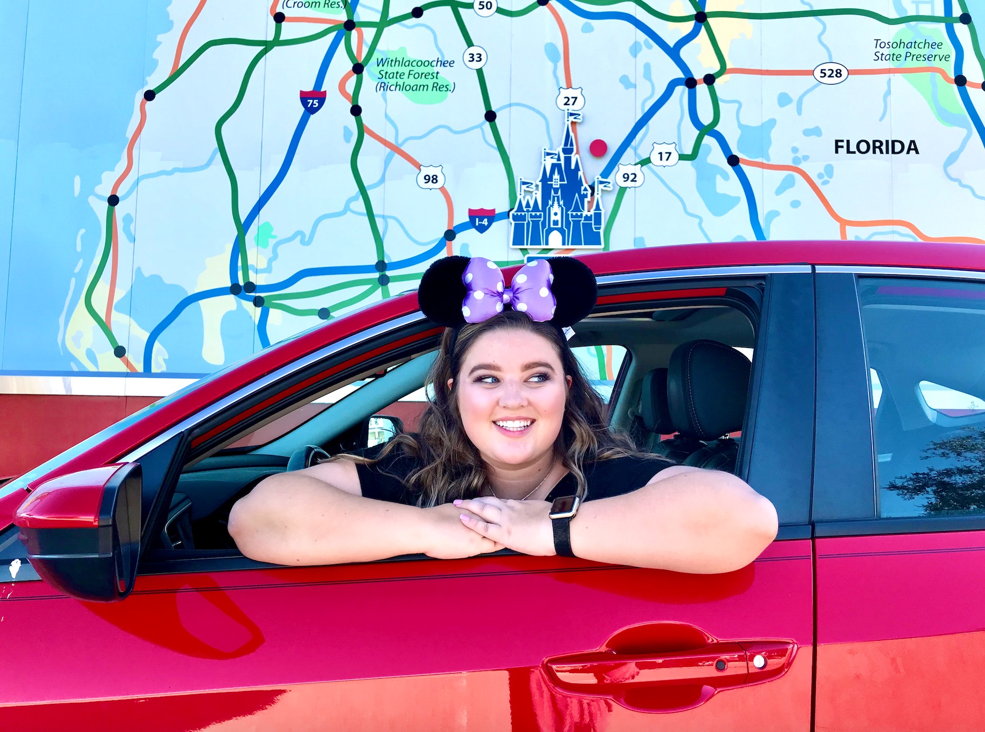 Woman in car going to Disney World