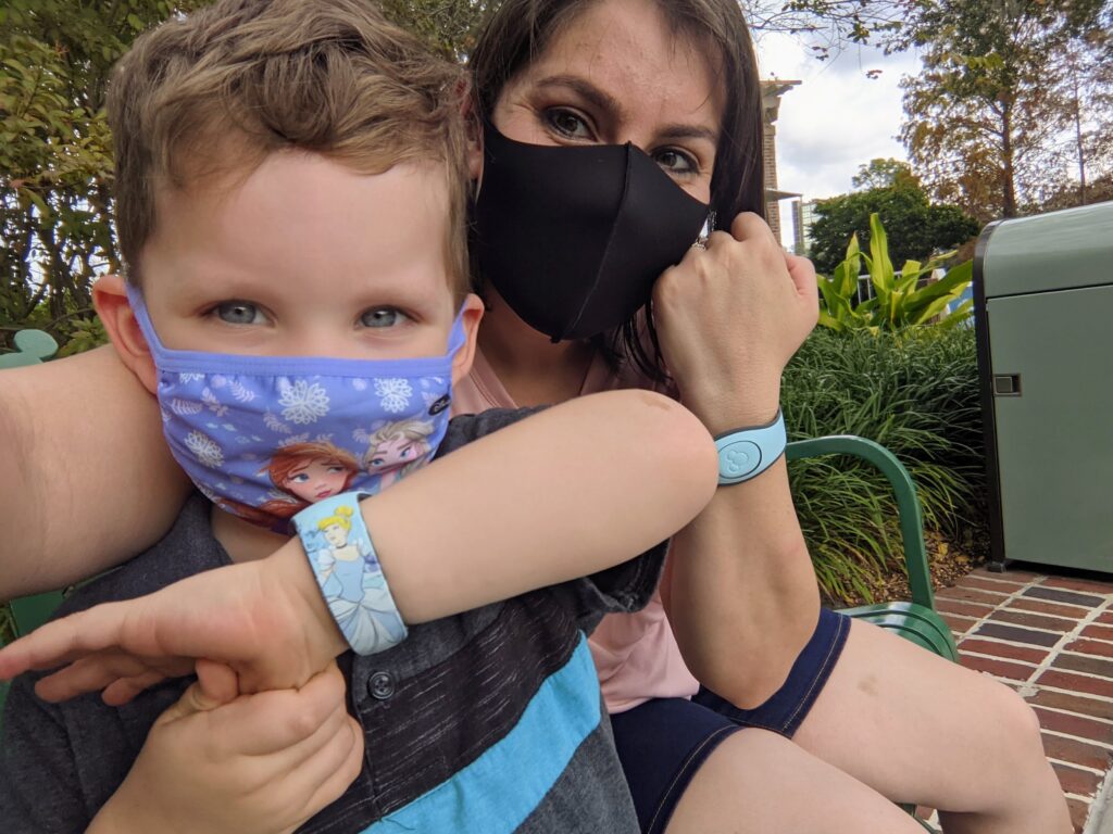 Child posing with his Cinderella Magic Band at Disney Springs