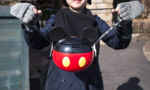 Girl holding Mickey Mouse popcorn bucket
