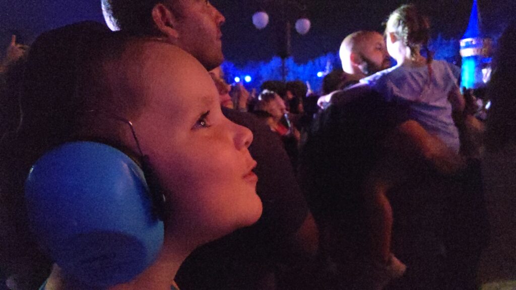 Lincoln wearing his noise muffling headphones for the Magic Kingdom fireworks