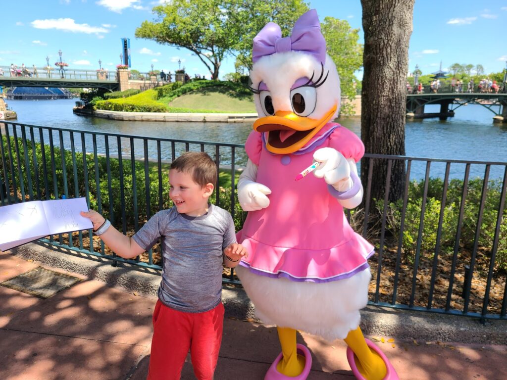 Daisy Duck Meeting Guests and Signing Autographs at Epcot's International Gateway