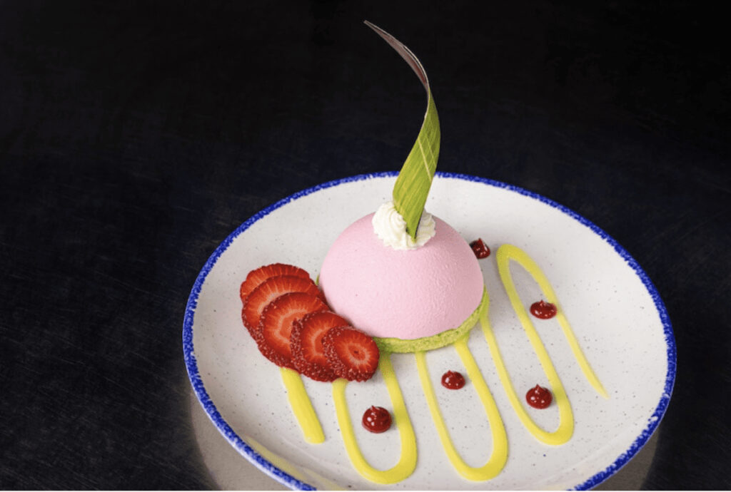 Strawberry-pistachio dome with strawberry-lemon gel and ruby chocolate powder from Coral Reef Restaurant