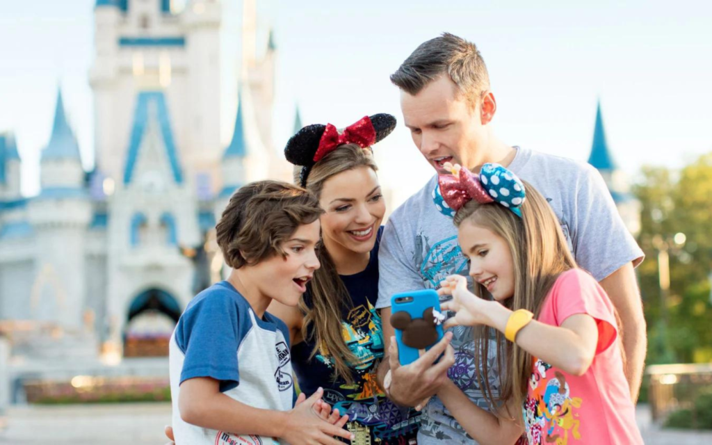 Family at Walt Disney World looking at phone