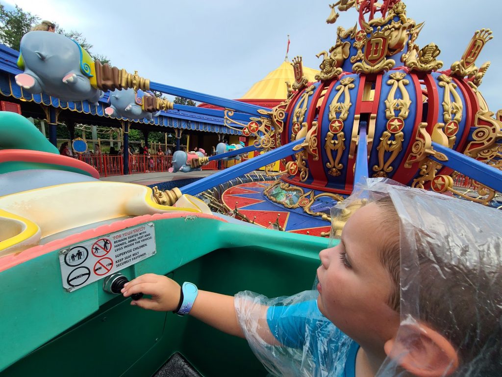 Lincoln riding Dumbo in the rain at Magic Kingdom