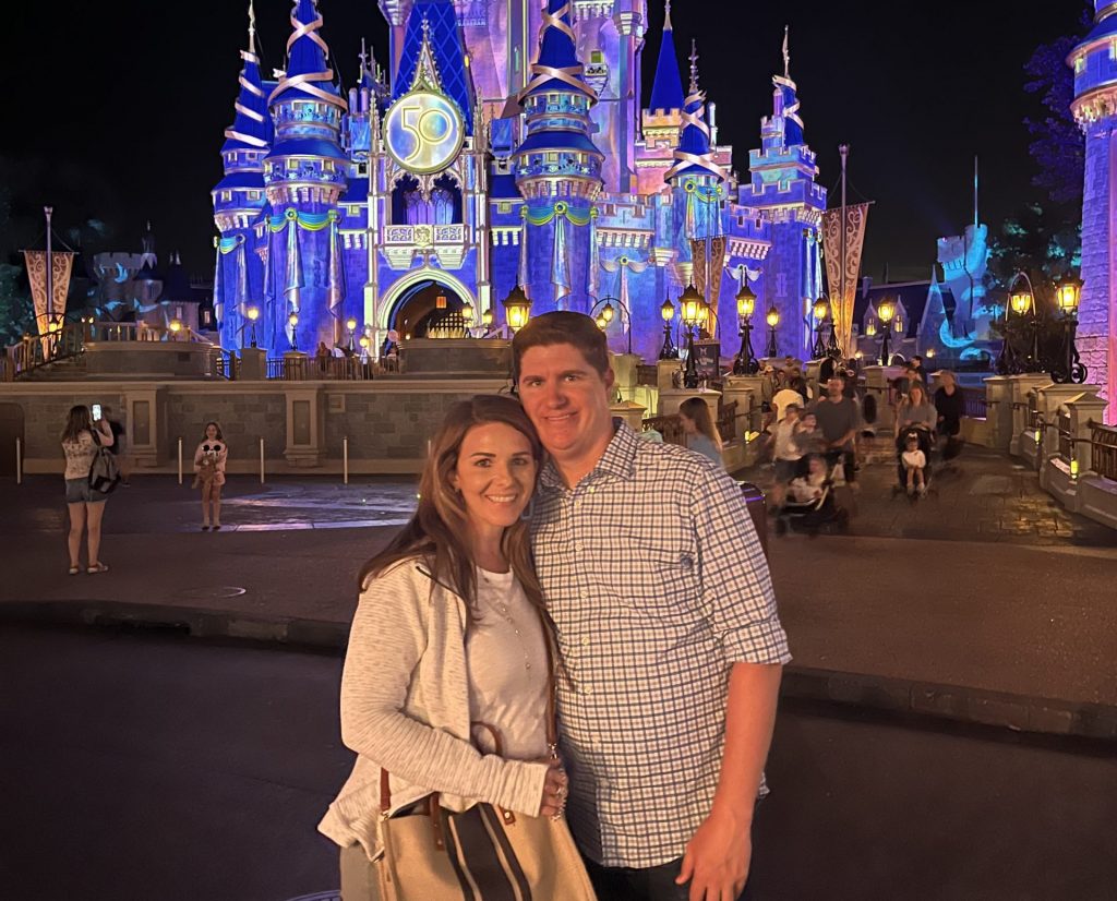 Couple photo in front of Cinderella Castle