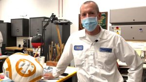 Disney cast members paint pumpkin