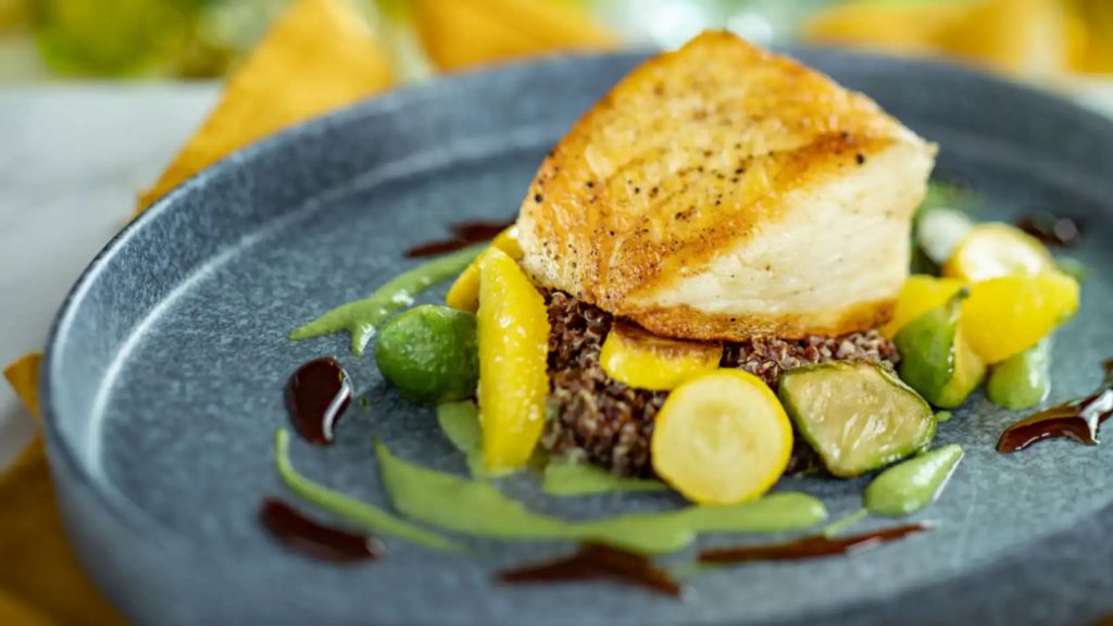 A filet of fish over a bed of quinoa and vegetables - California Grill