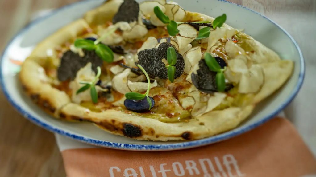 A personal pizza topped with fresh herbs and truffle shavings - California Grill
